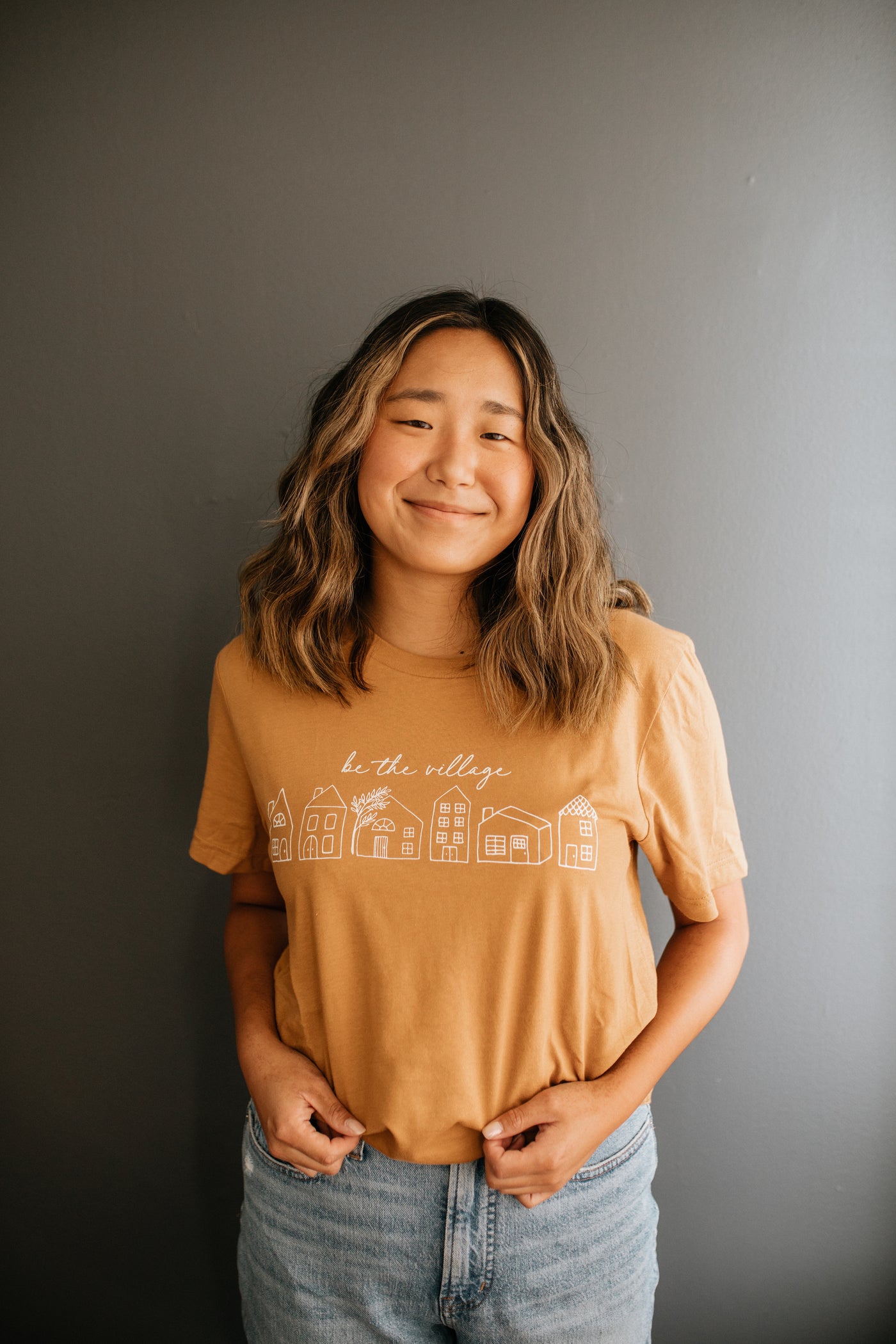 BE THE VILLAGE T-SHIRT - TAN – Goods and Better